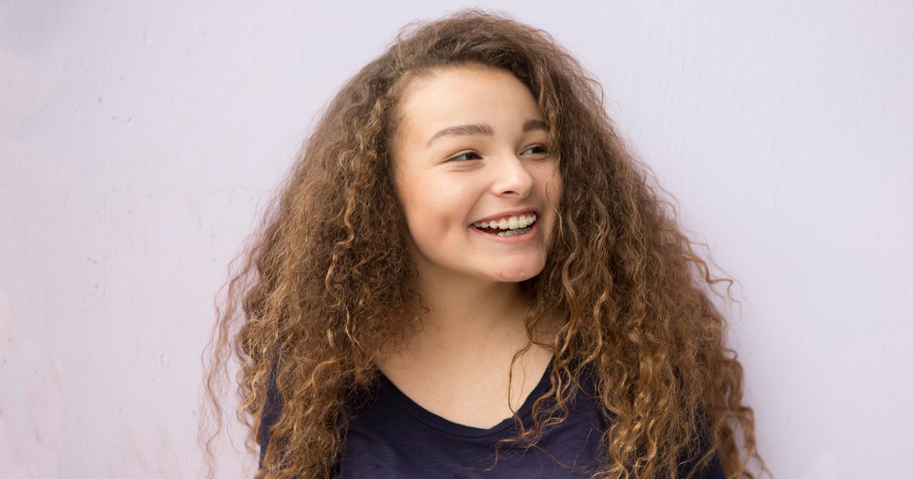 Teenager smiling indoors