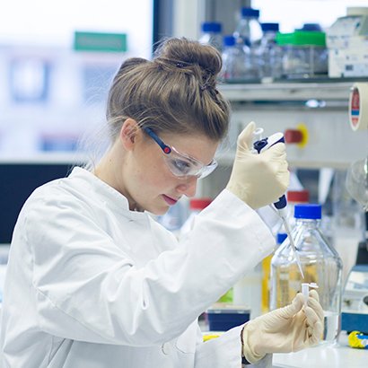 Biologist working in laboratory with pipette