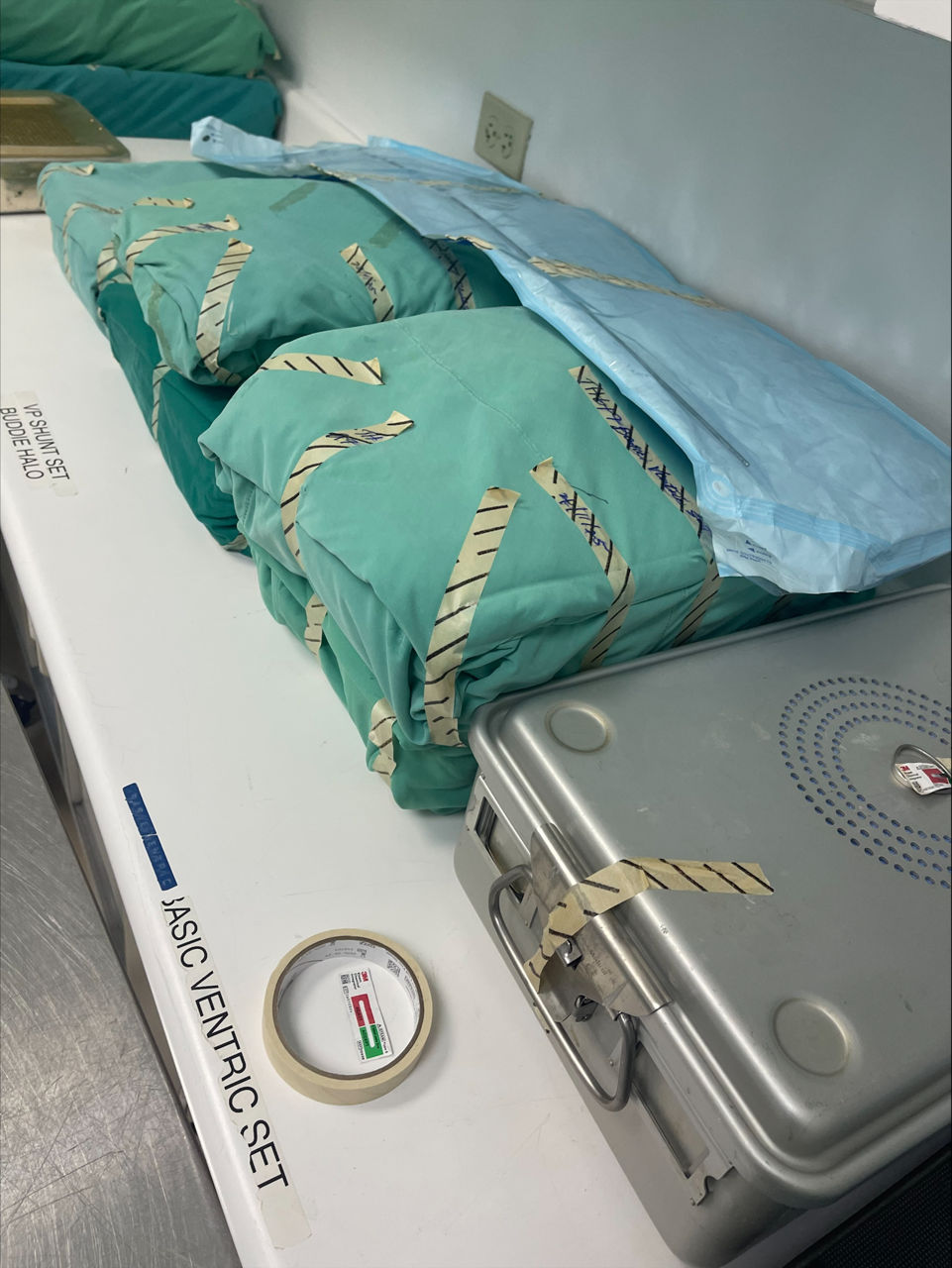 An Attest Steam Chemical Integrator lies on a table with sterilized processed containers.