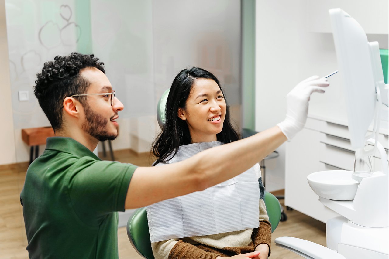Young patient talking to dentist about oral health during check-up, Berlin, Germany