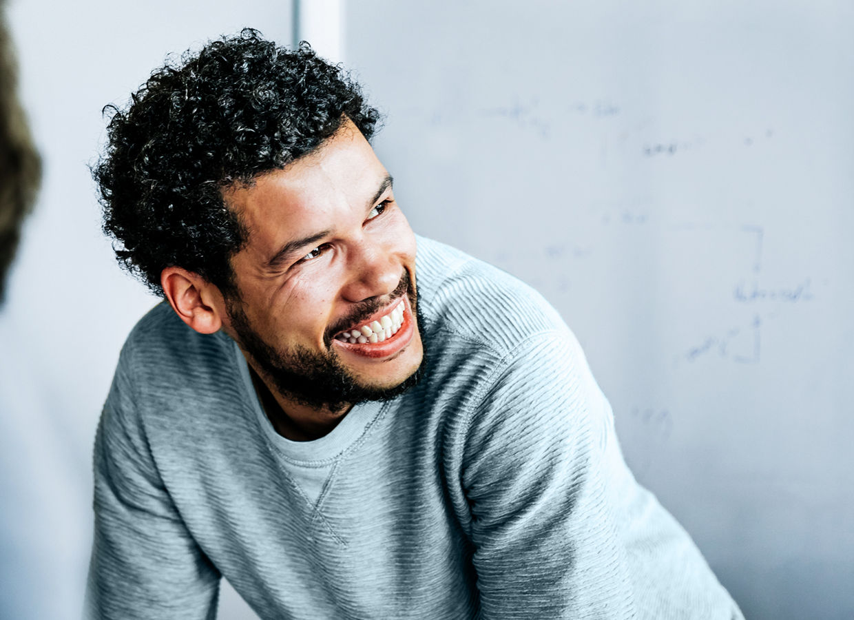 Man in casual clothing interacting in a conference room.