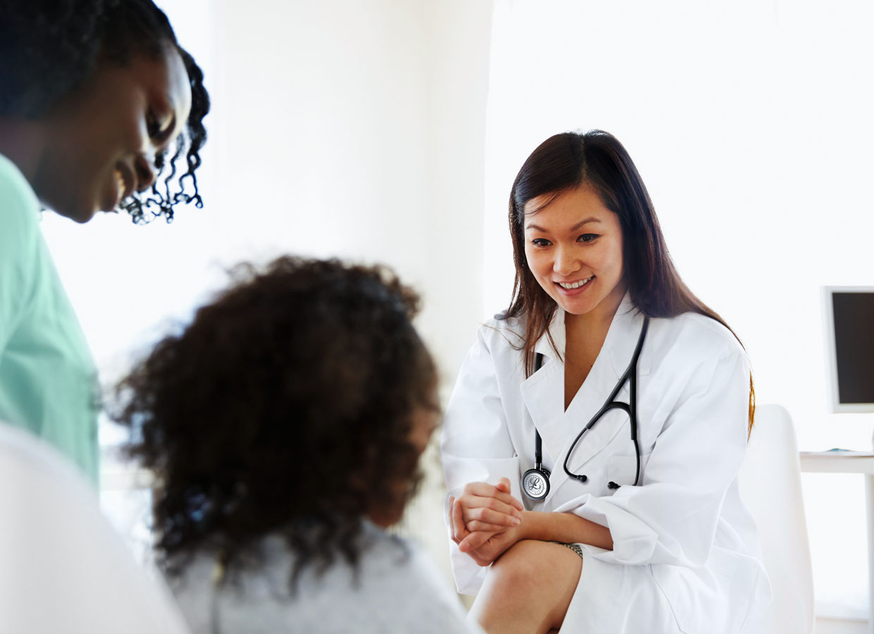 Doctor talking to girl with mother