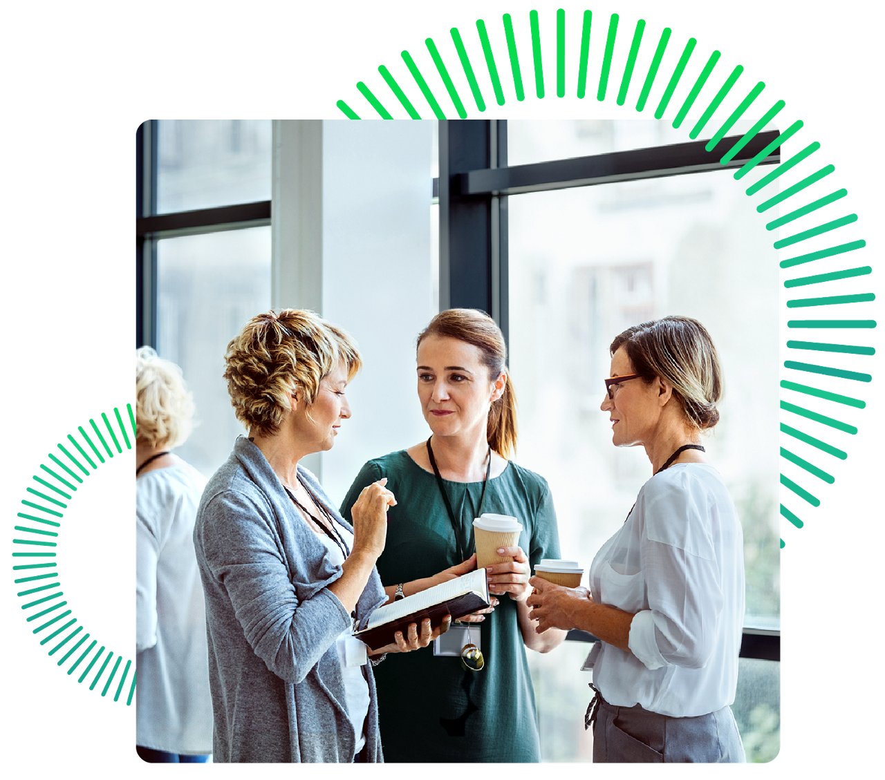 Three women talking with coffee by large windows
